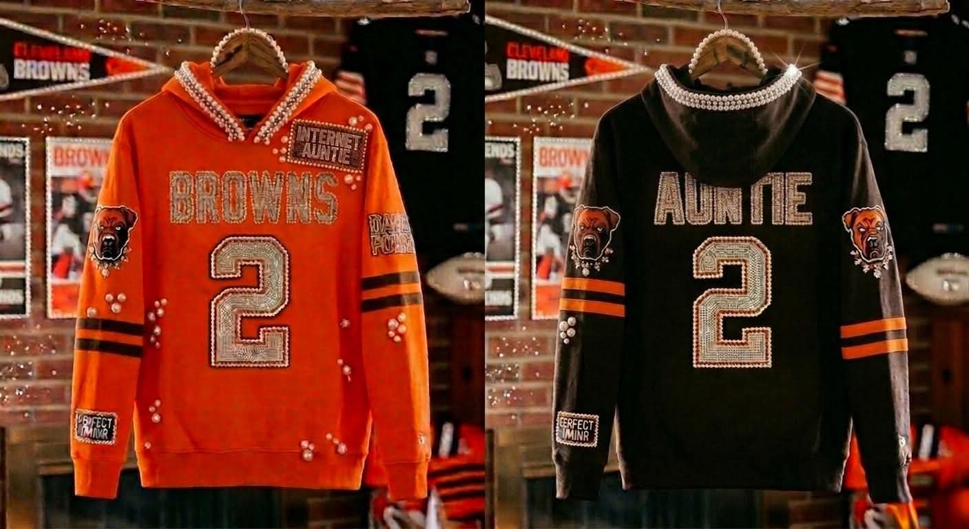 Two hockey jerseys, one orange and one black, with the number 2 and team logos displayed on hangers.