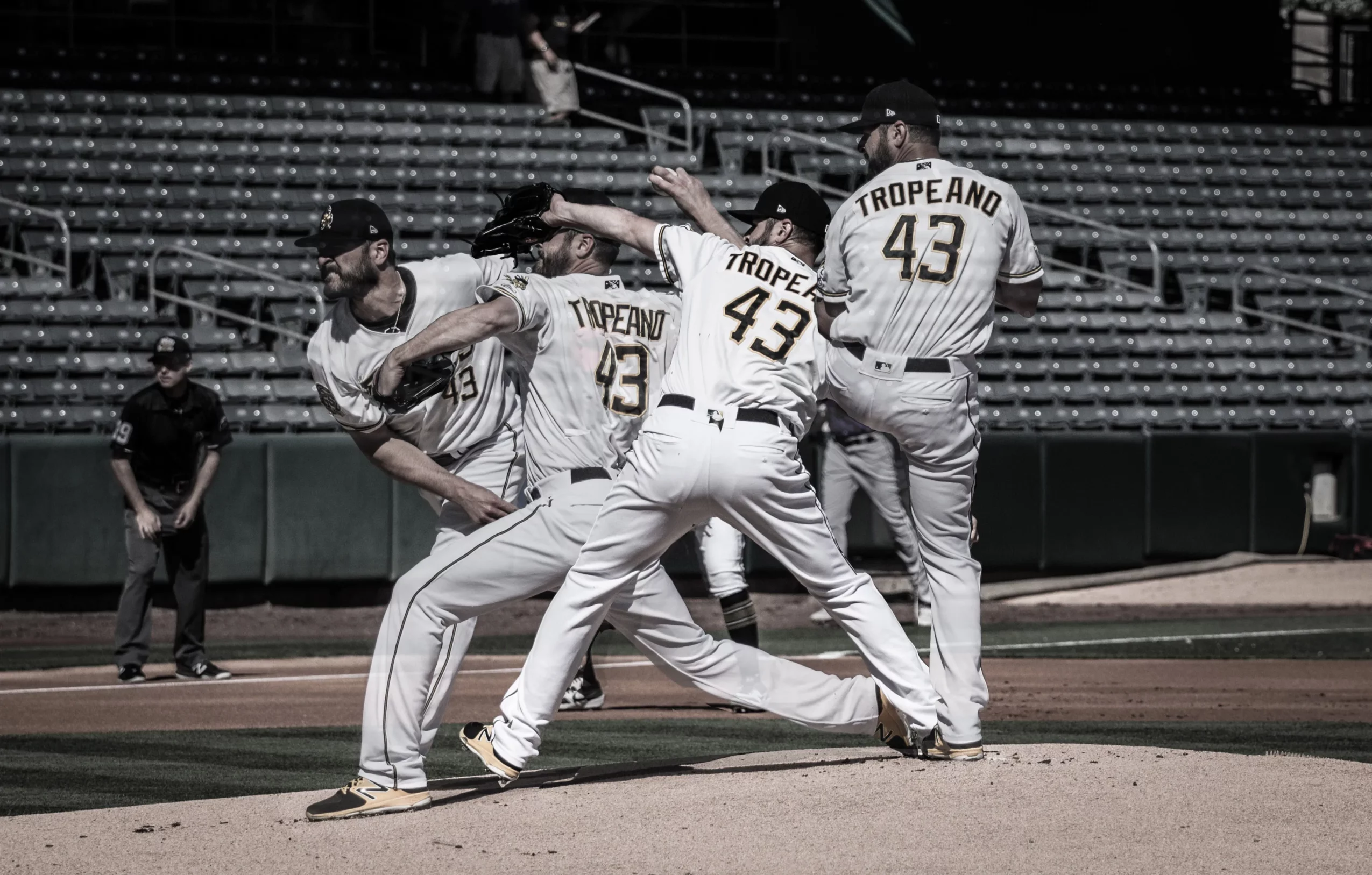 Baseball players in uniforms with 'TROPEANO 43' celebrate on the field, with empty stadium seats in the background.
