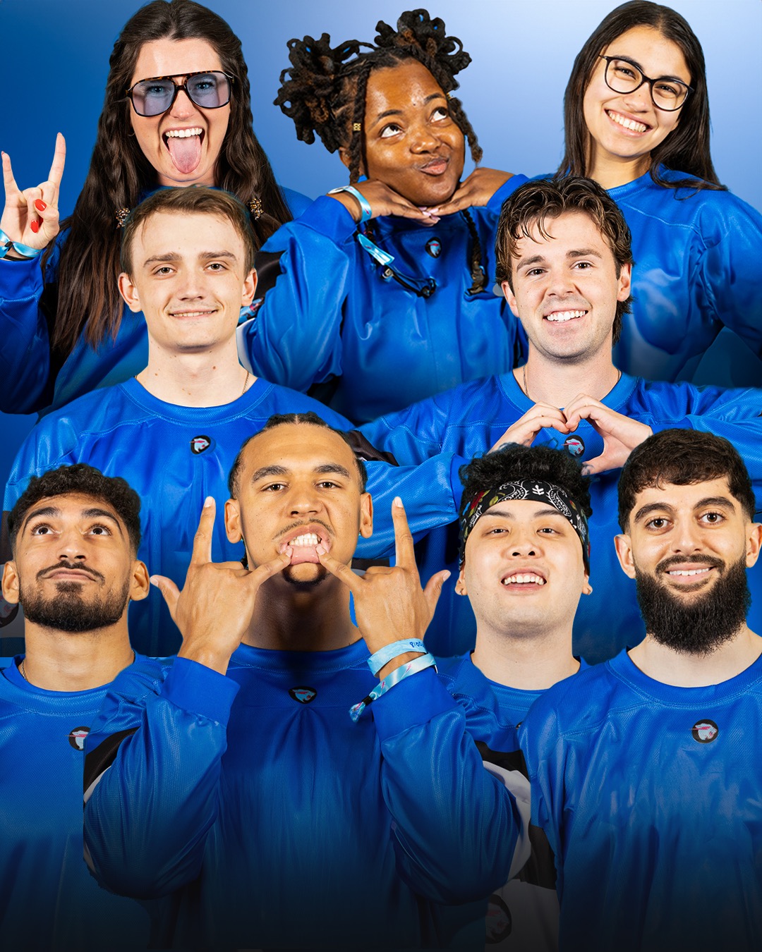 Group of nine diverse young people in blue sports jerseys smiling and making gestures against a blue background.