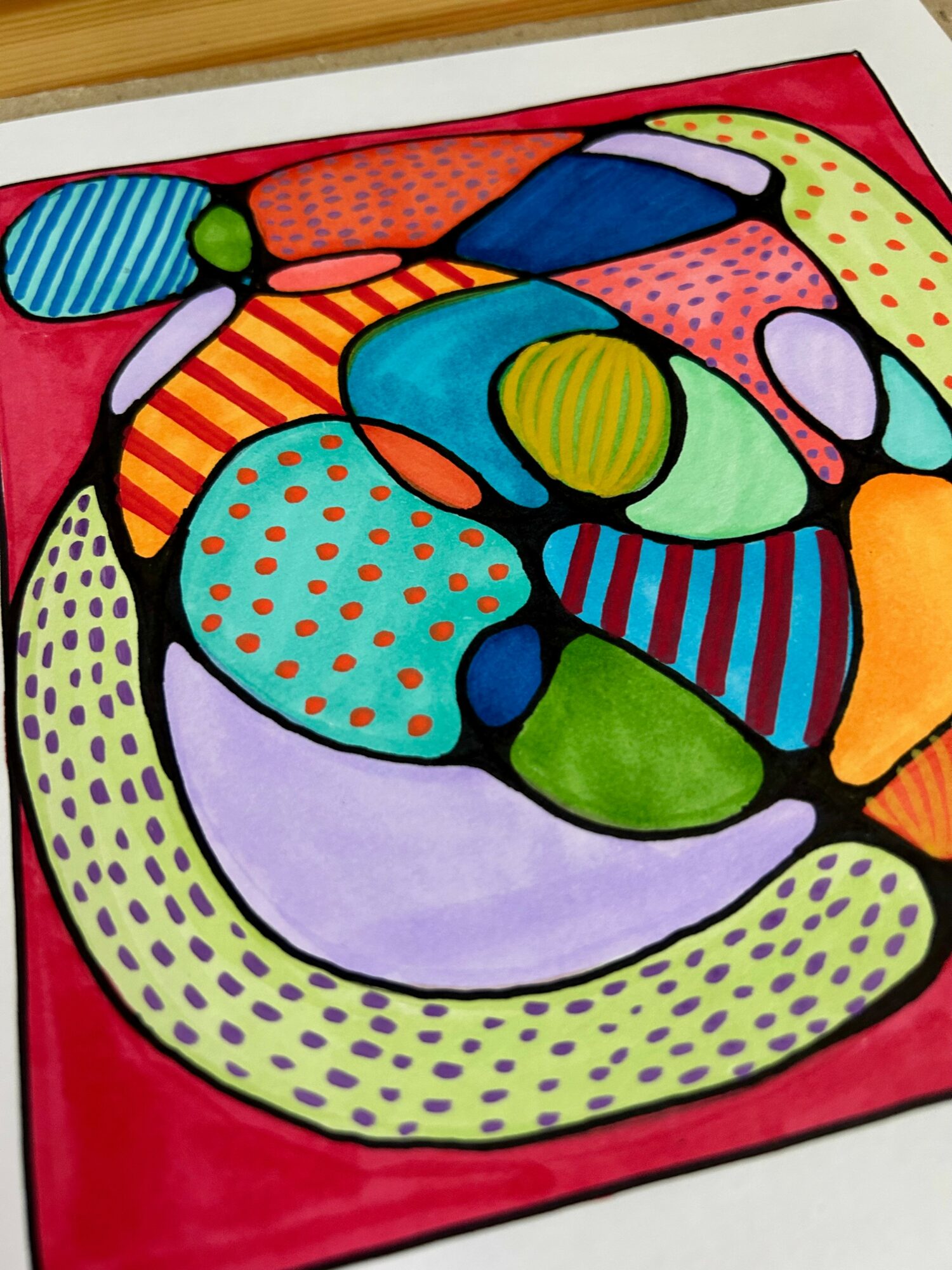 Colorful abstract shapes with dots and stripes on a red background, resembling a modern art piece.