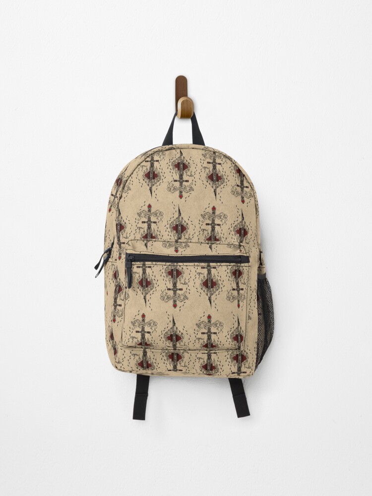 Backpack with a beige patterned fabric, black straps, hanging on a wall hook, front view, plain background.