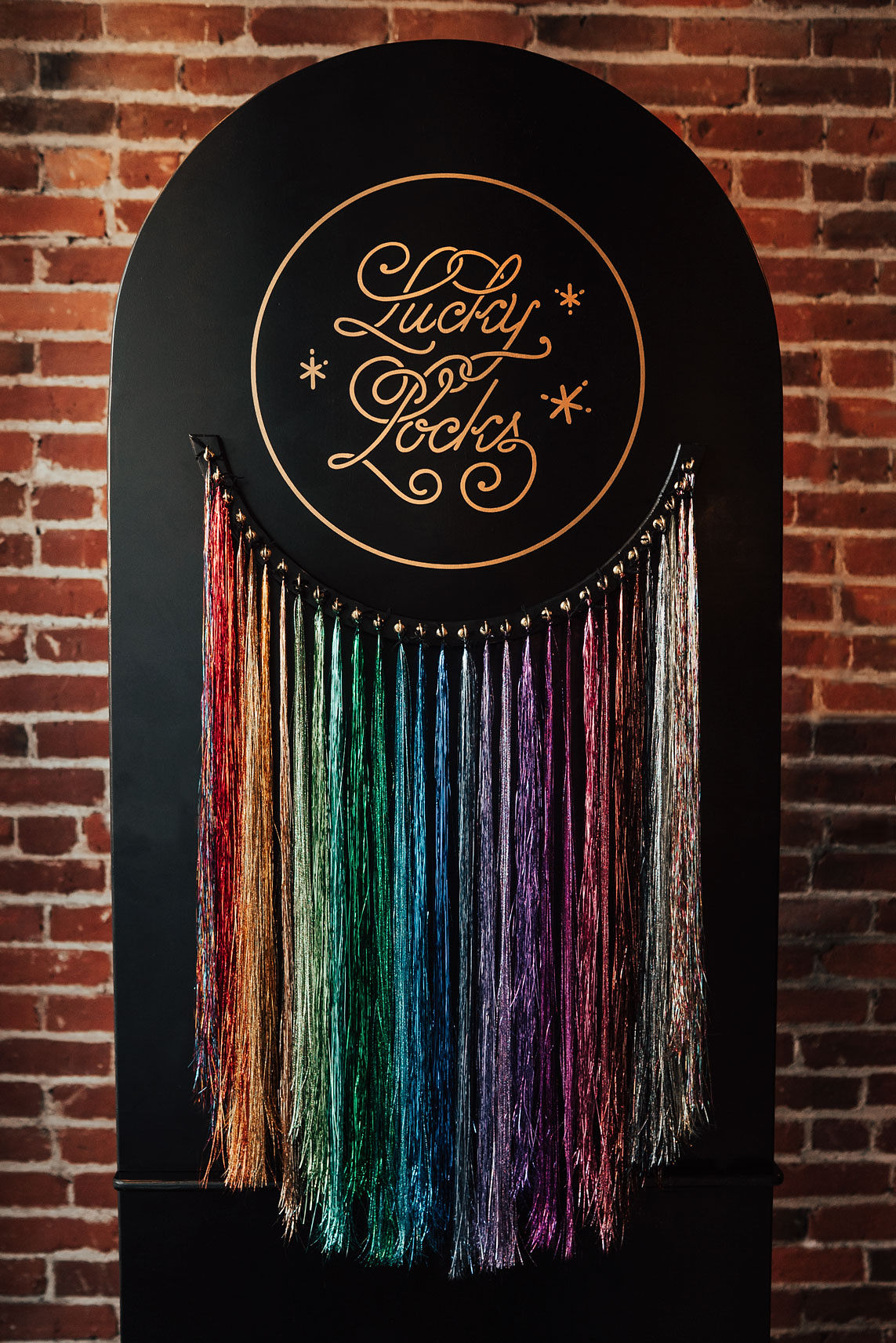 Black circular sign with gold text reading